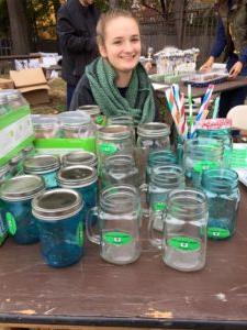 a student with mason jars and reusable straws